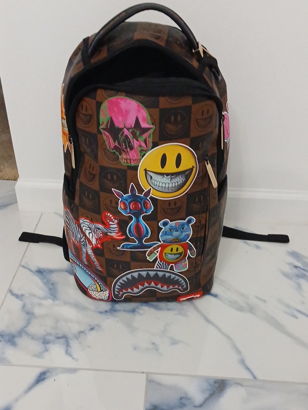 Sprayground Brown Checkerboard Backpack with Multicolor Sticker Graphics